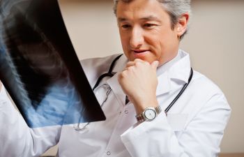 A physician revising an xray of a bone fracure